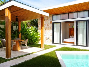 A modern house with a pool, a covered patio with a table and chairs, and a bedroom with a large window. - Villa Palmira - 2 bedroom Bali style Pool Villa (Bo Phut)