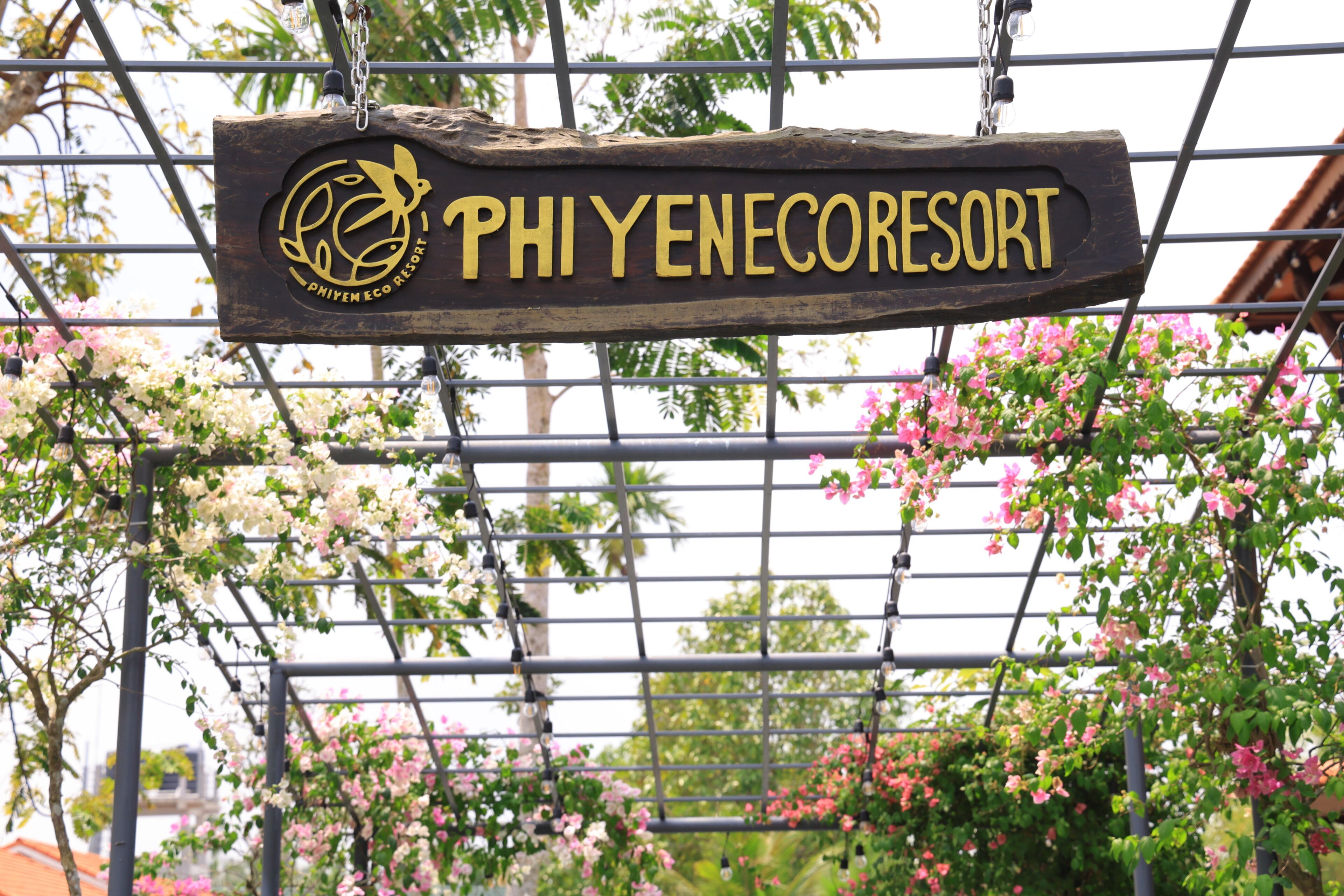 A sign for Phi Yenecoresort with a logo and name.