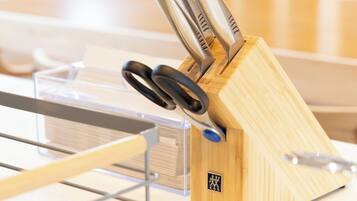 A kitchen area with a wooden knife block holding several knives.