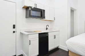Fridge, microwave, coffee/tea maker, cookware/dishes/utensils