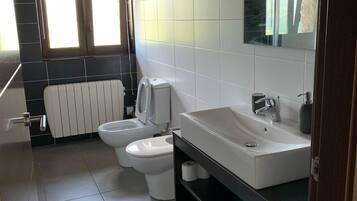 Een douche, een haardroger, een bidet, handdoeken