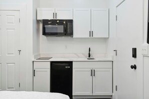Fridge, microwave, coffee/tea maker, cookware/dishes/utensils