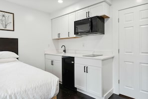 Fridge, microwave, coffee/tea maker, cookware/dishes/utensils
