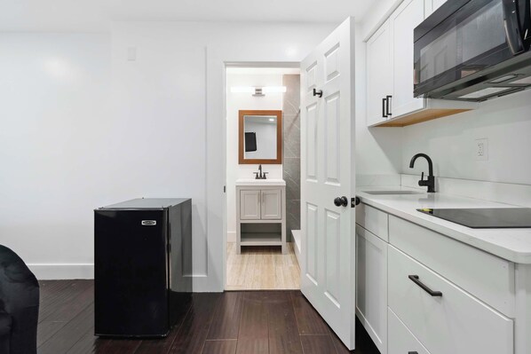 Fridge, microwave, coffee/tea maker, cookware/dishes/utensils