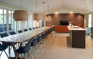 A modern meeting room with a long table, chairs, and a TV screen. - Lovely home in Ulfborg with sauna (Ulfborg)