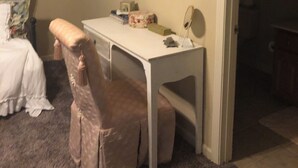 A bedroom with a bed, a desk, a chair, and four framed pictures on the wall. - Charming 2-bedroom townhome in welcoming Auburn with AC, WiFi, 1897 Sqare feet (Auburn)