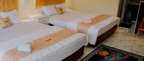 Two single beds with white linens, a wooden headboard, and a decorative rug with a fish design.