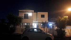 A two-story building with a balcony and a car parked in front. - Luxury Villa - Sleeps 4, Hottub Jacuzzi & Parking (Tías)