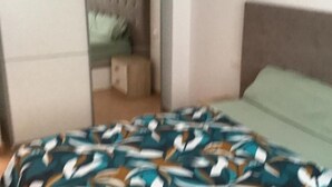Una camera da letto con un letto, un comodino e uno specchio.