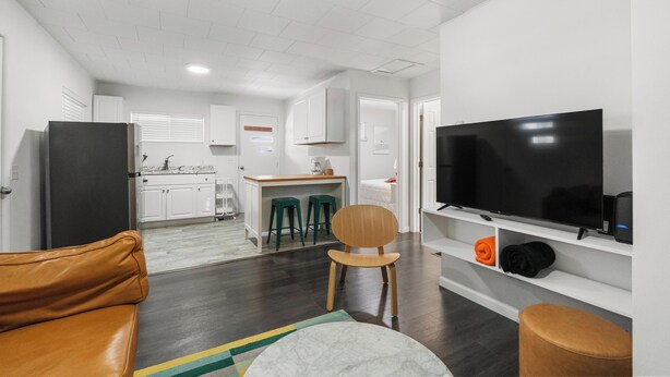 A modern apartment with a living room, kitchen, and dining area. - The Grove 1/2 mile from Boyne Mountain Sleeps 4 (Boyne Falls)