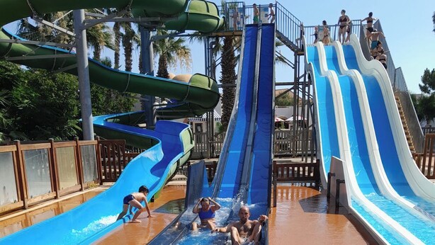 A water park with multiple water slides and a pool area.