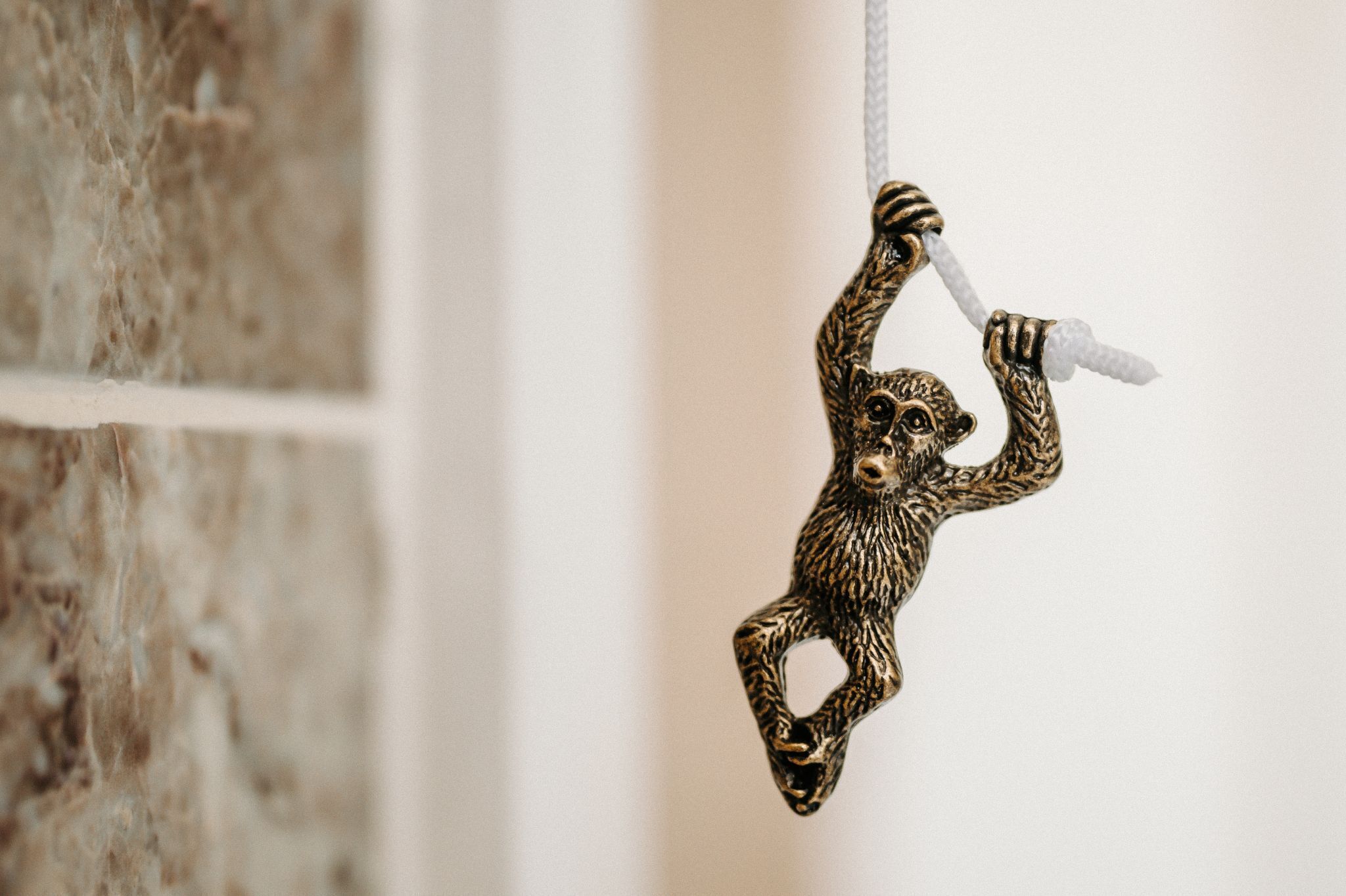 A monkey-shaped ornament hanging from a string.