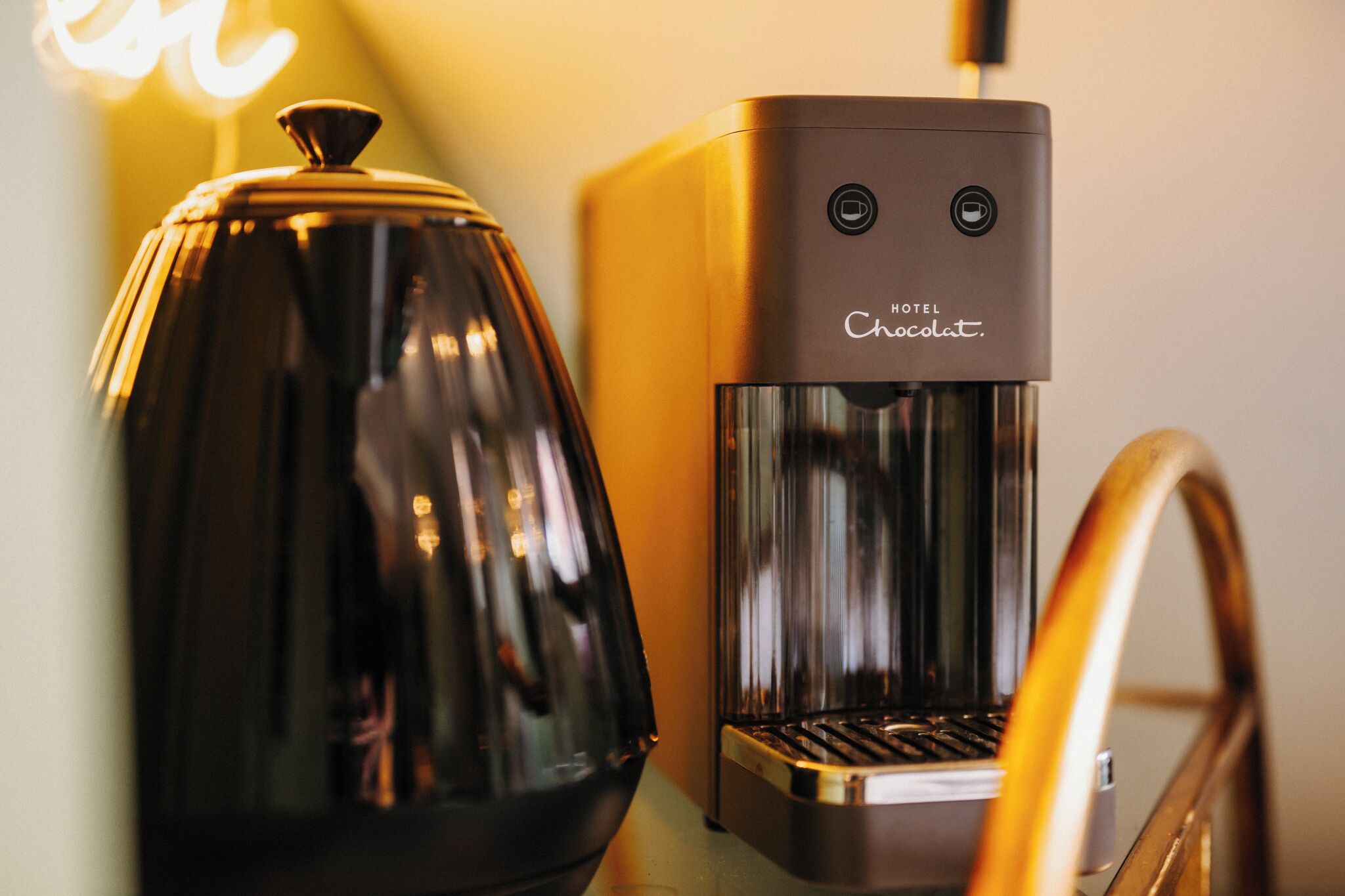 A coffee machine and a glass carafe on a counter.