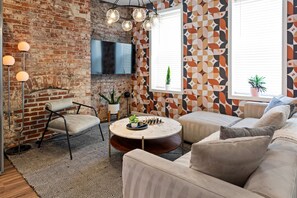 Relax in this cozy space with a flat-screen TV, comfortable sofa, and a round coffee table for games and conversation.