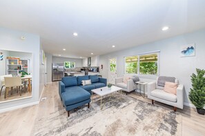 Relax in this stylish living space with a blue sofa, white armchair, and small table.