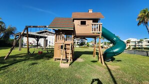 A wooden playground with a slide and swings. - Villa Haven Giovanni (Vega Alta)