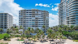 A modern hotel with multiple floors, balconies, and a beachfront view. - Charming 1-bedroom condo in delightful Pompano Beach with WiFi, AC (Pompano Beach)