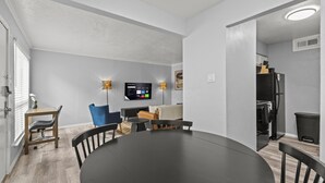 A modern kitchen with a black refrigerator, a stove, and a sink. - Stylish & Comfy | King Bed | Near Love Field | DT (Dallas)