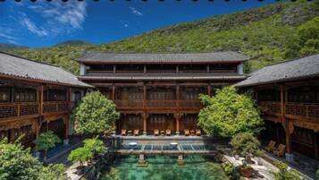 A traditional building with a courtyard, wooden architecture, and a clear sky.
