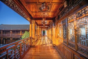 Un pasillo con barandillas de madera y elementos arquitectónicos chinos tradicionales.