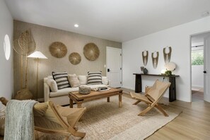 A modern living room with a sofa, coffee table, and two chairs. - Private Balcony | Coastal Escape (Summerland)