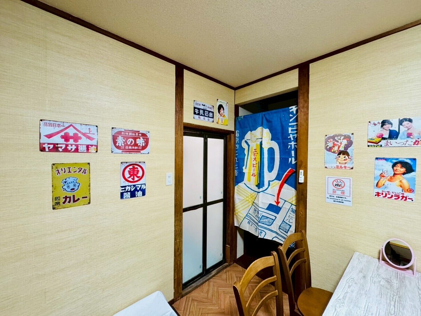 A restaurant interior with wooden walls, a large poster, and various signs indicating menu items and services.
