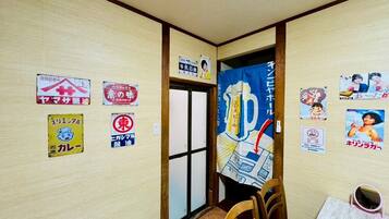 A restaurant interior with wooden walls, a large poster, and various signs indicating menu items and services.