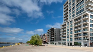 A modern multi-story building with balconies, a waterfront view, and a clear sky. - Baelskaai 25 with balcony by Interhome (Oostende)