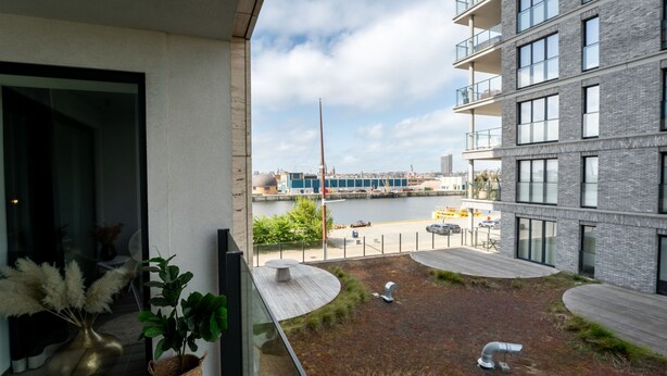 A modern building with a view of a marina and boats. - Baelskaai 25 with balcony by Interhome (Oostende)