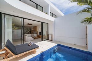 A modern house with a pool, a lounge chair, and a staircase leading to a second floor. - Elements A4 Villa Bingin (Pecatu)