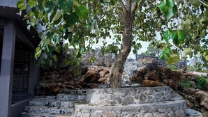 A stone staircase with mosaic tiles leading up to a building entrance. - BlueHill Lotus Holistic Wellness Village (Sirumalai)