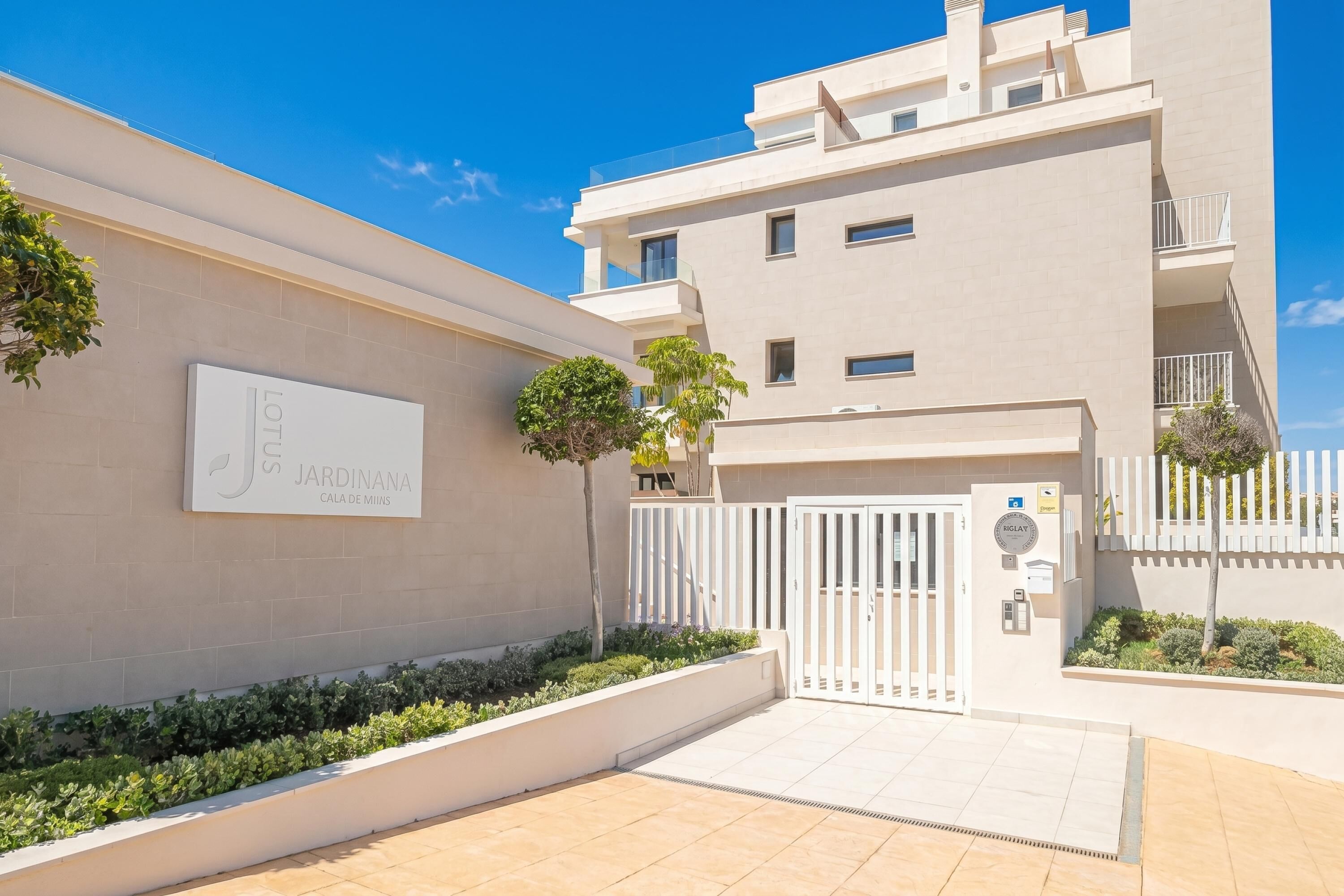 A modern building with a sign reading 'LOTUS JARDINANA CALA DE MIJAS.'