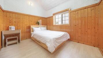 A bedroom with a wooden bed, a nightstand, a window, and a ceiling light.