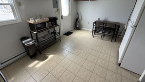 A compact kitchen with a refrigerator, a microwave, a coffee maker, and a sink. - Keel at Soundview · Beach+OceanView+Sunrise (Old Lyme)