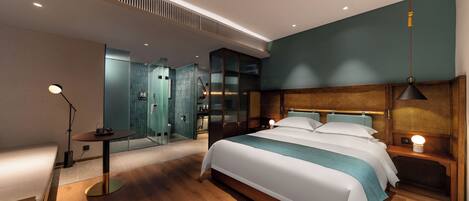 A modern hotel room with a large bed, bedside tables, a desk, and a mirror.