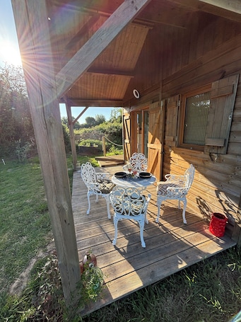 Outdoor dining. A cottage in an orchard