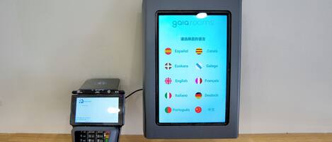 A mobile device displaying a language selection screen with various options including Español, Català, and others.