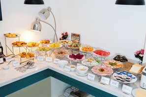 A buffet with various food items and labels. - A25 Premium Hotel - 130 Ba Trieu (Hanoi)