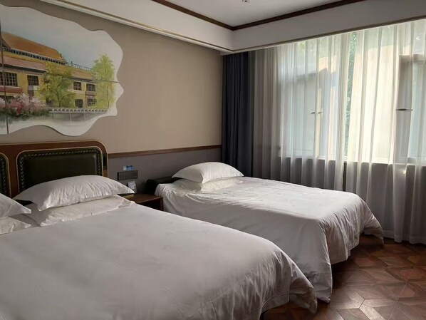 Family Triple Room | Free minibar, individually decorated, desk, laptop workspace