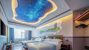 A hotel room with a large bed, a desk, and a chair. There is a painting on the wall and a ceiling with a starry design. - Nostalgia S Hotel(Tianjin Jinwan Plaza) (Tianjin)