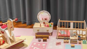 A dollhouse with a vanity table, a bed, and a small table with a mirror.