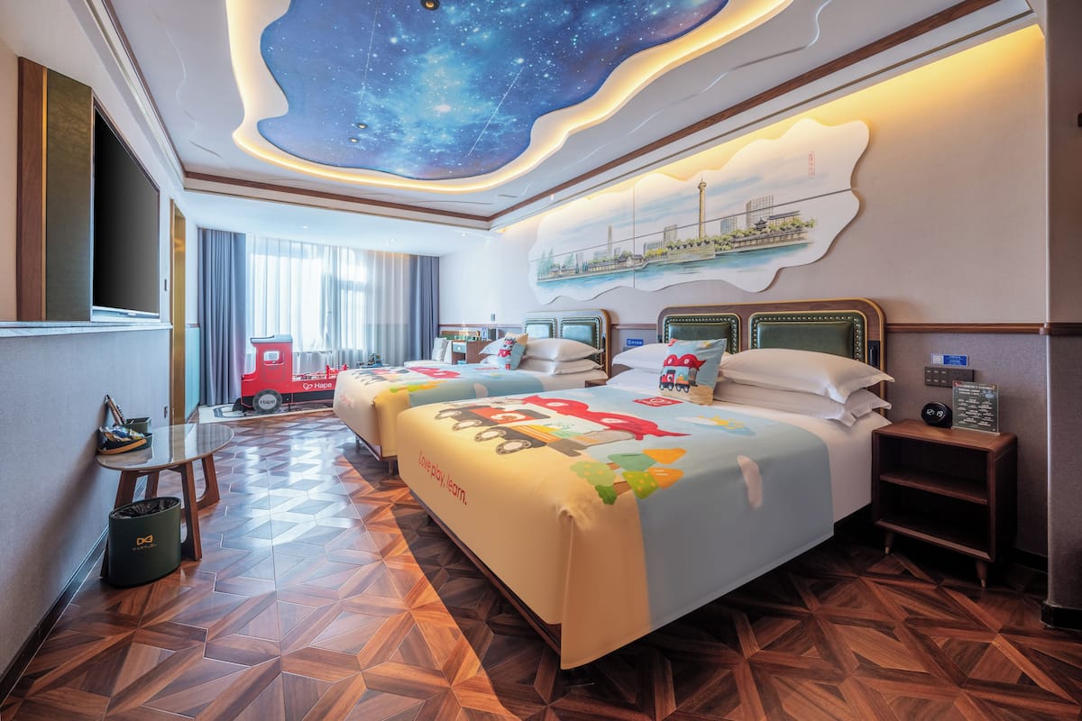 Family Quadruple Room | Free minibar, individually decorated, desk, laptop workspace