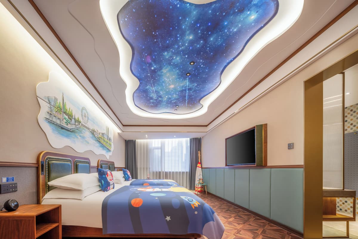 Family Quadruple Room | Free minibar, individually decorated, desk, laptop workspace