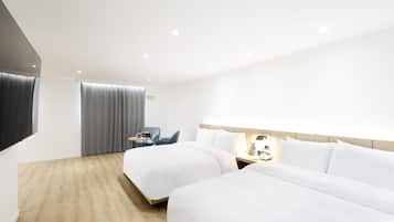 A modern hotel room with two beds, a desk, and a chair.