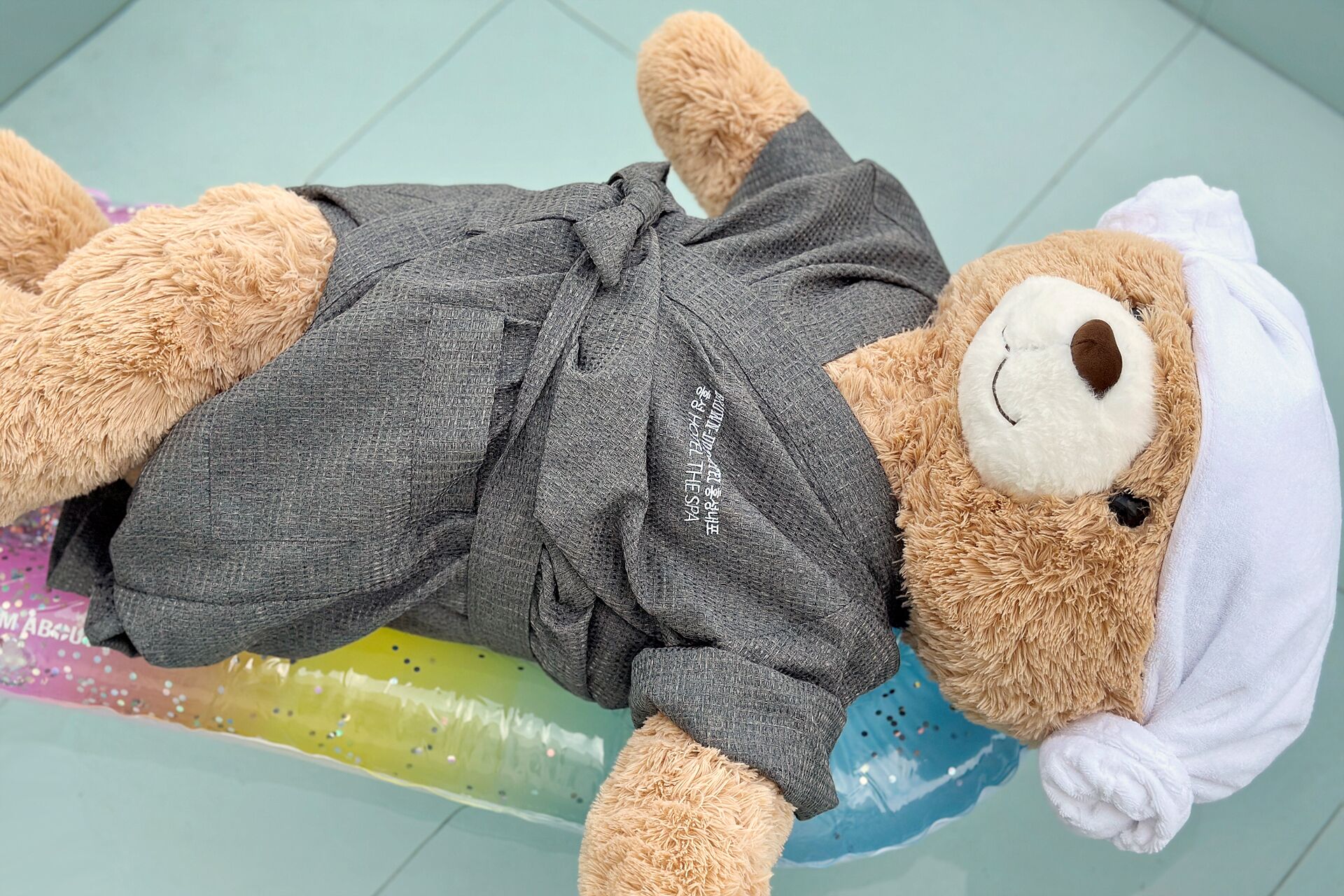 A plush toy lying on a colorful surface.