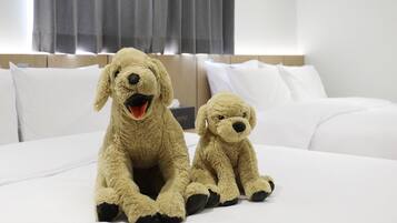 A bed with two plush dog toys.