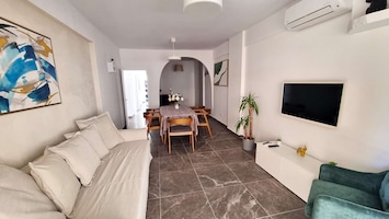 Living room + TV + Sofabed + dining area