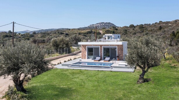 A modern house with a swimming pool, surrounded by olive trees and a hilly landscape. - Marinas villas (Rhodes)