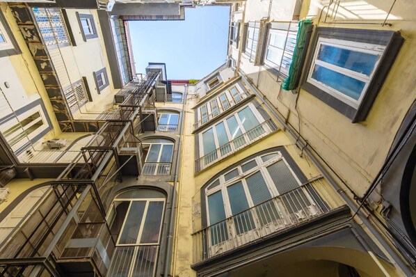 A multi-story building with external staircases and balconies.