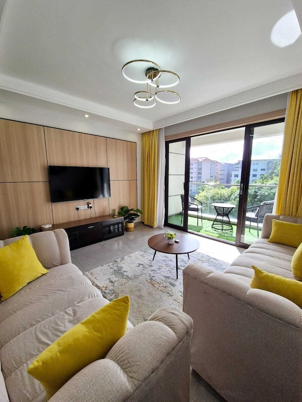 Executive Apartment, Balcony, City View | Living area | 32-inch Smart TV with digital channels - Lux suites 108 Riverside Apartments (Nairobi)
